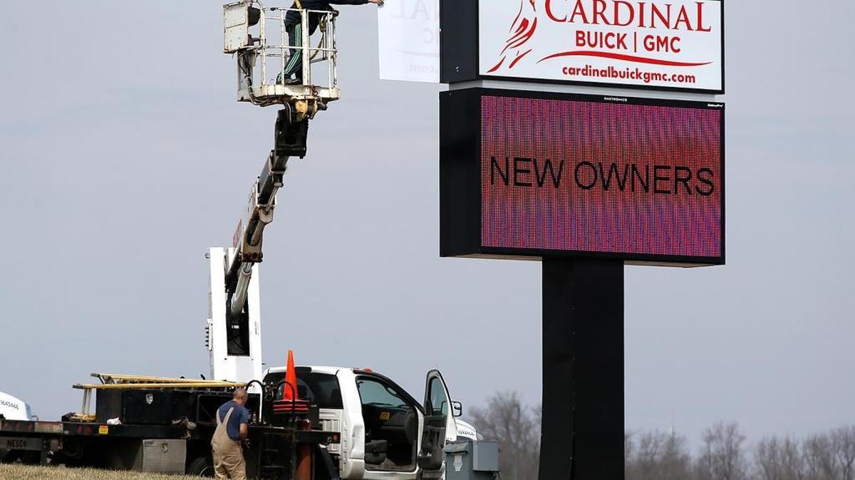 This file photo shows a Cardinal Buick GMC sign being installed at the Belleville dealership on Illinois 15 in 2017.