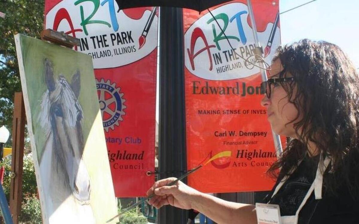Anne Molasky Ibur takes advantage of the beautiful weather on Saturday and paints a picture during Art in the Park in Highland.