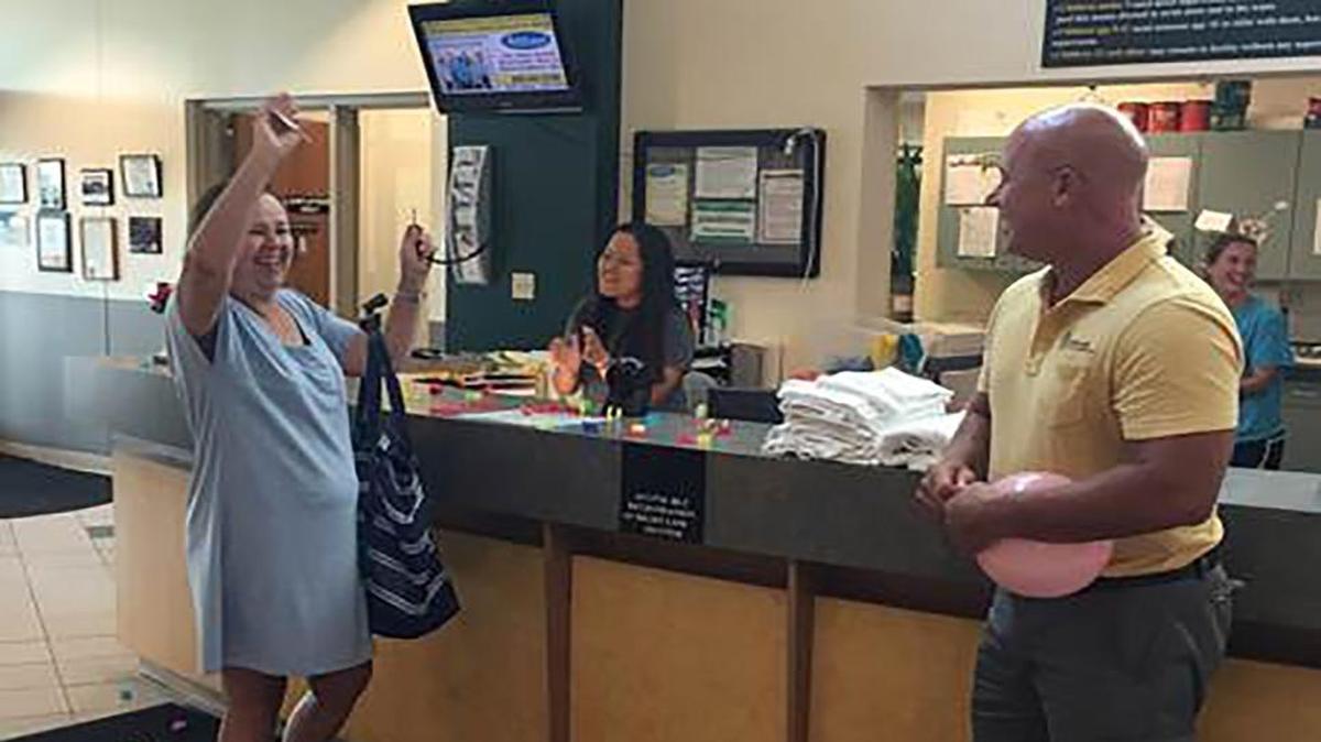 Linda Grissom of St. Jacob is excited to be the 2 millionth visitor to the Korte Recreation Center in Highland. Greeting her was Highland Parks and Recreation Director Make Rosen.