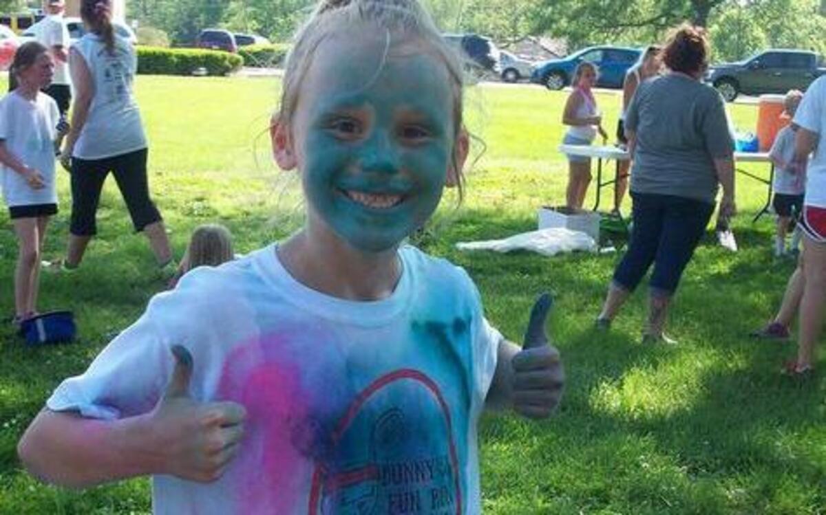 Highland Elementary held its Girls on the Run Color Run 5K after school on Tuesday, May 9 as a practice race for the final 5K in St. Louis on Saturday, May 13. At left, third-grader Kirstyn Carver shows off her color after she crosses the finish line. At right, fifth-grader Katelynn Woolf gets sprayed with color by volunteer Jake Heinzmann as she finishes her last mile. There will be a Color Run that is open to the public on Saturday, June 24 at 7:30 p.m. at Glik Park in Highland. Registration forms can be picked up at the Korte Recreation Center, Highland Elementary or registration can be done online at runsignup.com.