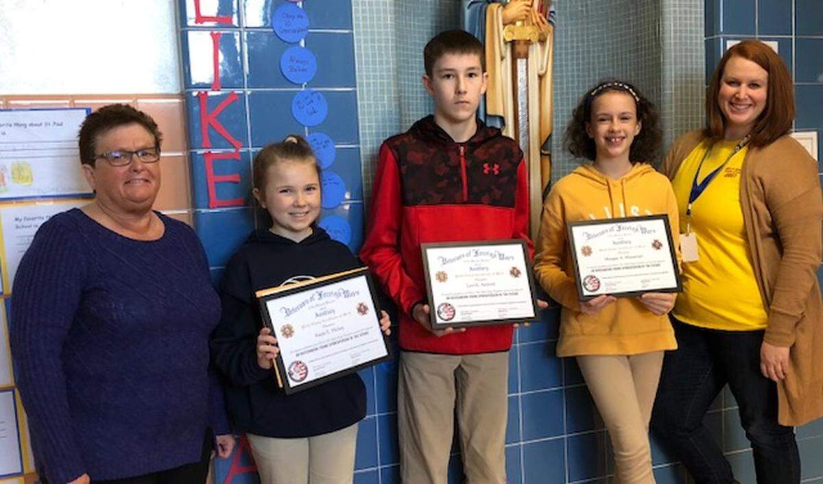 Patriots Pen Essay winners were presented to students at St. Paul Catholic School from Highland VFW Post 5694 and Auxiliary . From left are Scholarship Chairman Nancy Rieke; Kayla Hickey, first place; Levi Ashford, second place; Meagan Wieseman, third place; and teacher Suzanne Horan. The theme for 2018-19 was “Why I Honor The American Flag.”