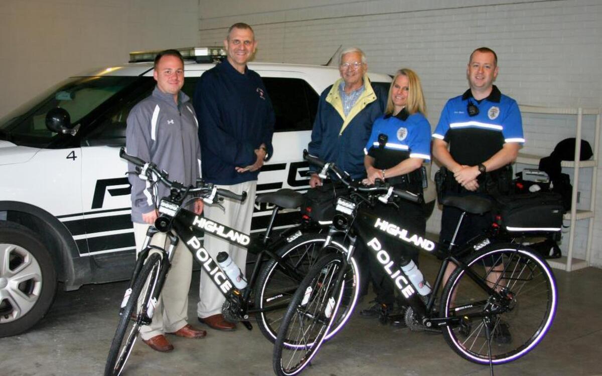 MCT staff presents two patrol bikes to members of the Highland Police Department. From left are MCT staff member David Cobb, Highland Chief of Police Terry Bell, MCT Managing Director Jerry Kane, and HPD officers Heather Kunz and Shawn Bland.