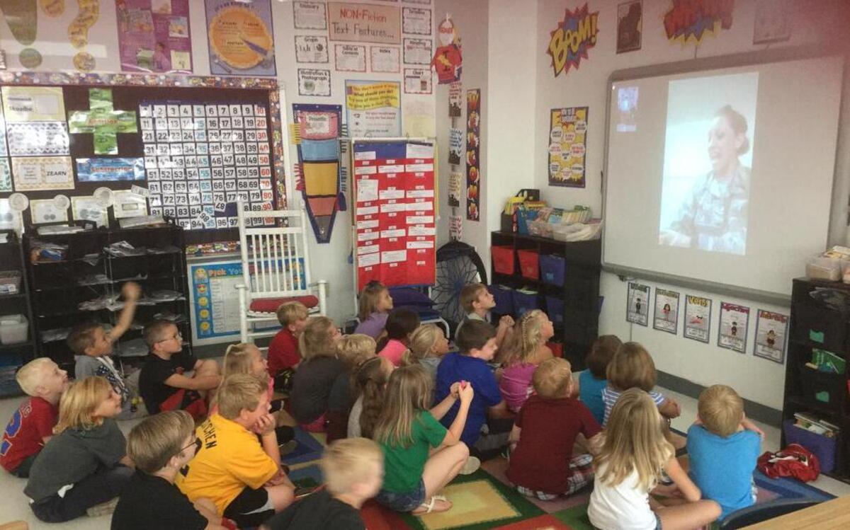 Students in Jessica Warnecke’s second-grade class at Highland Primary listen as Amber Brenton, is serving in the Army and is currently deployed in the Persian Gulf nation of Qatar, reads to them via computer link. Brenton is a mother of a student in the class.