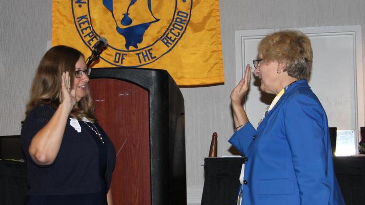 On Oct. 11 Lana Hediger, left, is sworn in as the president of the Municipal Clerks of Illinois.