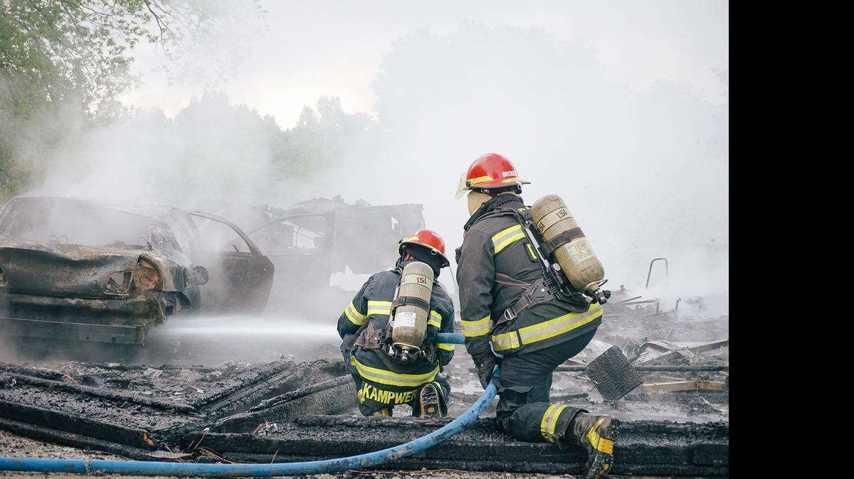 
HPFD captains Jerod Kampwerth and Phil Decker extinguish the fire.
