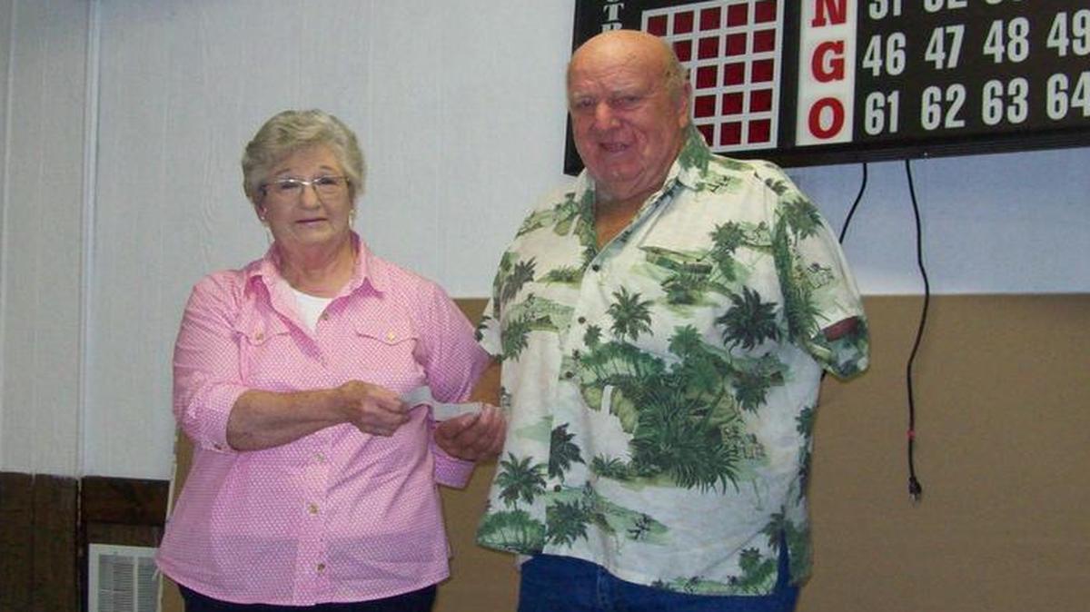 
St. Jacob Mayor Pro Tem Pattie Beil receives a check from the St. Jacob Lions Club President Alvin “Red” Noll for $1,280 representing the profit from the Bingo Stand at the 2015 St. Jacob Homecoming. Lions Member Dutch Jancek, chairperson of the bingo stand, stated that the bingo stand was a huge success with many volunteers working both nights of the Homecoming. The St. Jacob Lions Club holds a Bingo at the St. Jacob Activity Center every Saturday night, starting this Oct. 3, with the carryover Starburst Jackpot at $3,698.

