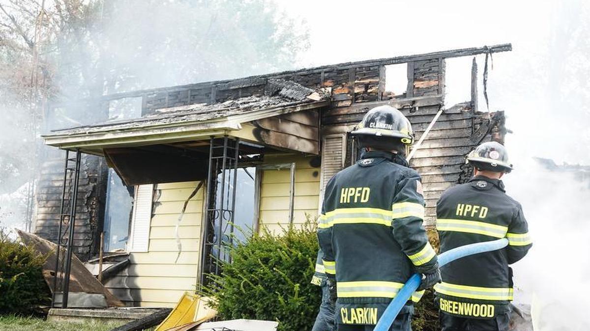 
Firefighters John Clarkin and Jerry Greenwood perform overhaul.

