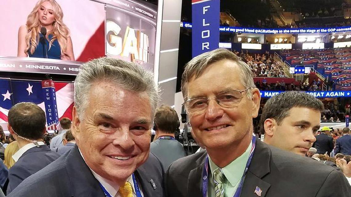 New York Congressman Peter King of New York poses for a photo with Phil Chapman of Highland, a Donald Trump delegate, on the floor of the Republican National Convention in Cleveland. Tiffany Trump, daughter of GOP nominee Donald Trump, can be seen on the video board in the background addressing the convention.