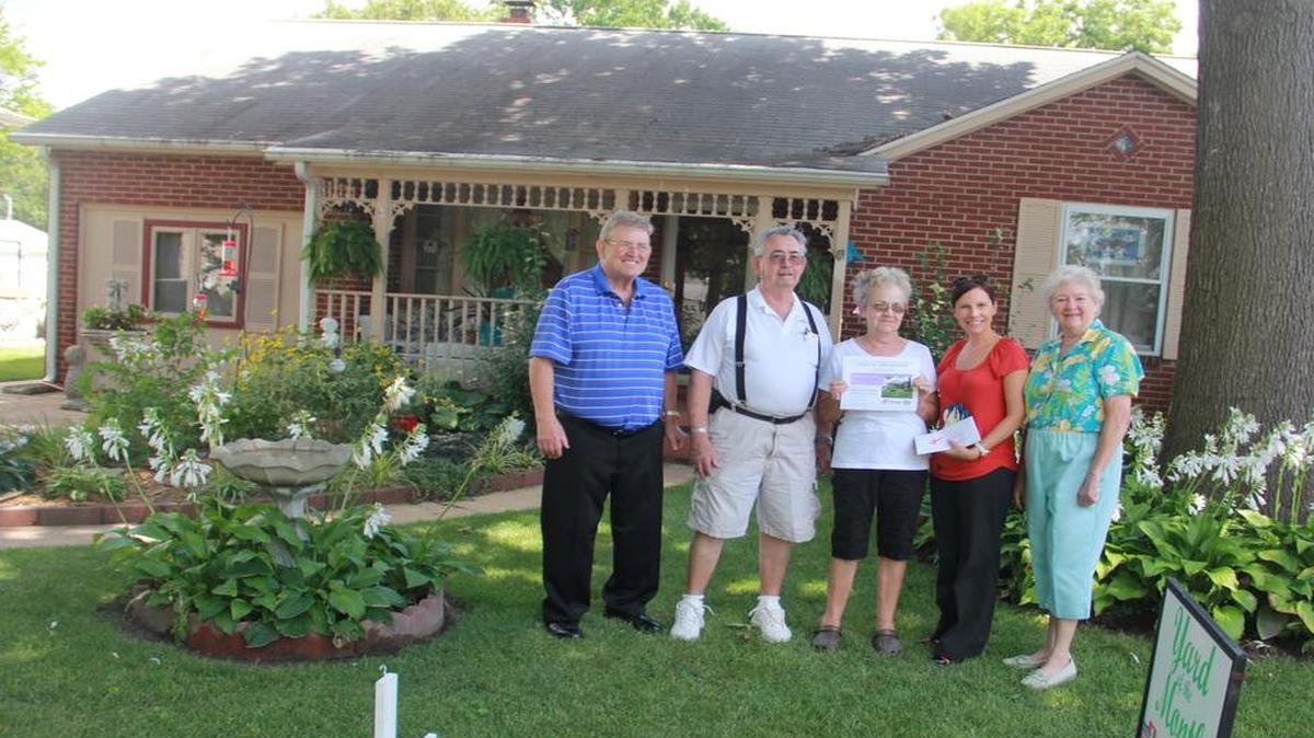 
A lovely cottage home has the yard of the month for August belonging to Kathy and Harry Buchanan of 1713 Cypress St. in Highland. Pictured, from left, are Highland Mayor Joe Michaelis, Harry and Kathy Buchanan, Nancie executive director of the Chamber of Commerce and Judy West of the Highland Garden Club.
