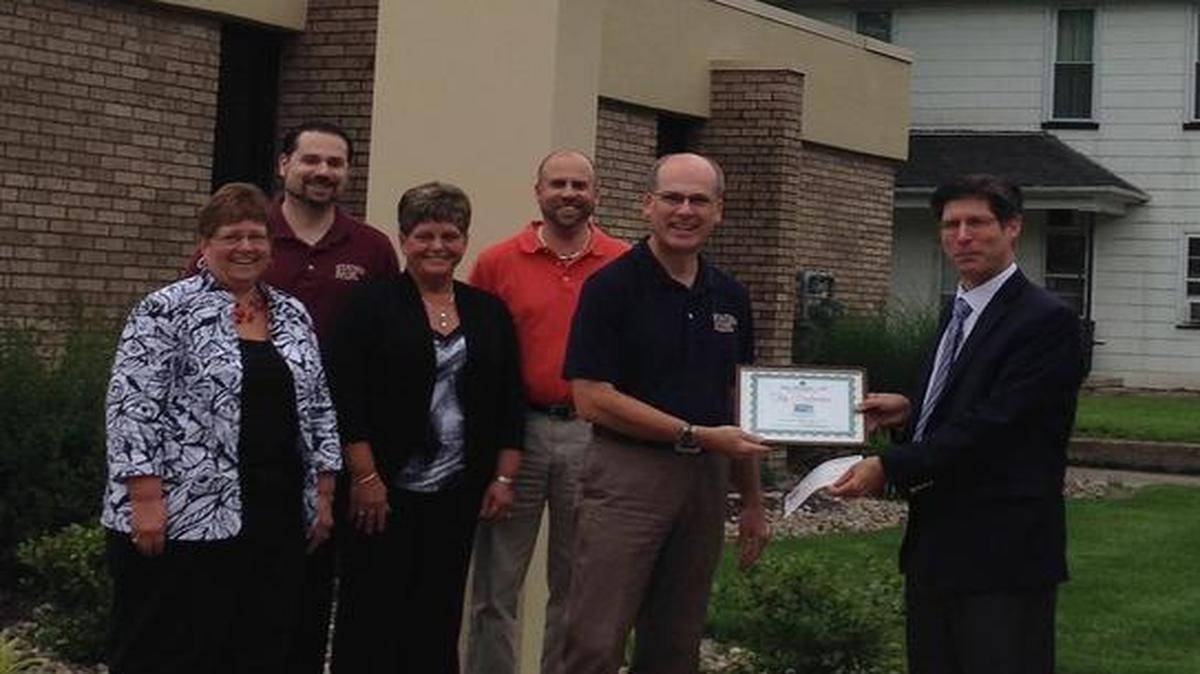 Madison County Treasurer Kurt Prenzler (far right) presents employees of State Bank of St. Jacob with the “Top Performer” certificate in the collection of real estate taxes. Bank employees, from left to right, Pam Schuette, Dave Prange, Debbie Seger, Scott Prange and Steve Prange.