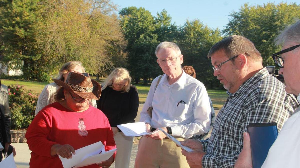 State Rep. Charlie Meier offers a prayer at Monday’s prayer vigil in front of his office. He is joined by United Congregations of Metro-East president Norma Patterson, Mike Berens, a leader with UCM and Mike Schuette, board chair of Catholic Charities of Southern Illinois and about 22 others who attended the vigil. UCM is seeking to overturn new rules put in place by Gov. Bruce Rauner regarding qualifications for childcare assistance.