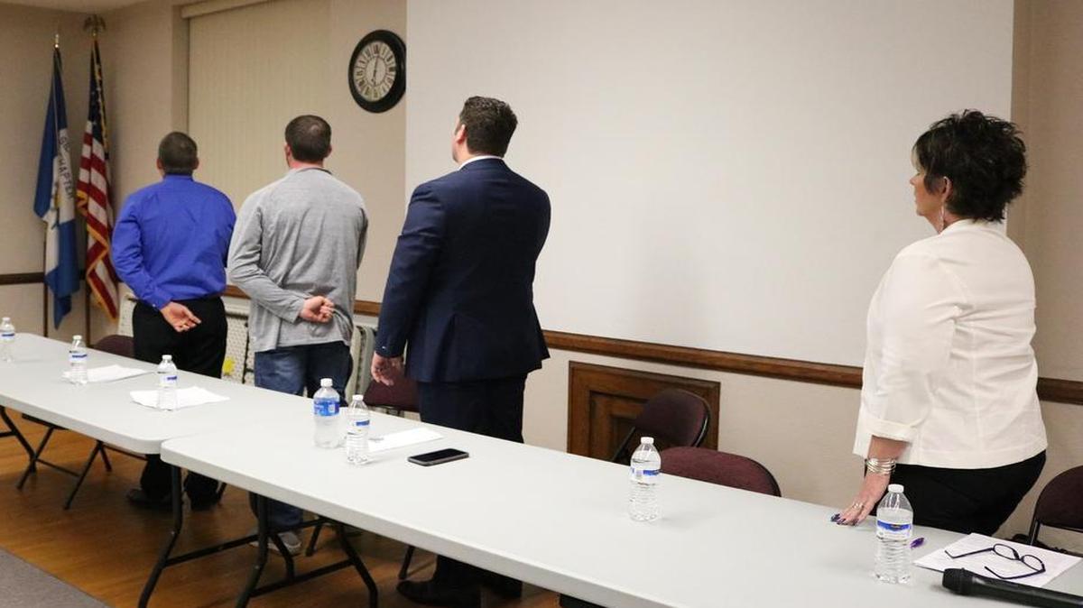 Aaron Schuster, Zach Lewis, John Hipskind and Rene Friedel (left to right), the Highland Community Unit School District #5 Board of Education election candidates, stand for the Pledge of Allegiance before the school board forum on March 9. The Chamber of Commerce hosted the forum at the Louis Latzer Memorial Public Library.