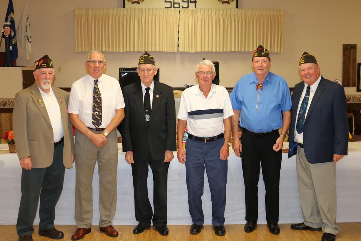 VFW 50-year pin State assistant membership director Lee Wallace, on left, helped present VFW 50-year pins were presented to, from left, Wesley Stueber, Francis Huelsmann, Leonard Frank and Wayne Moore. On far right is VFW Post 5694 commander Mike Voegele.