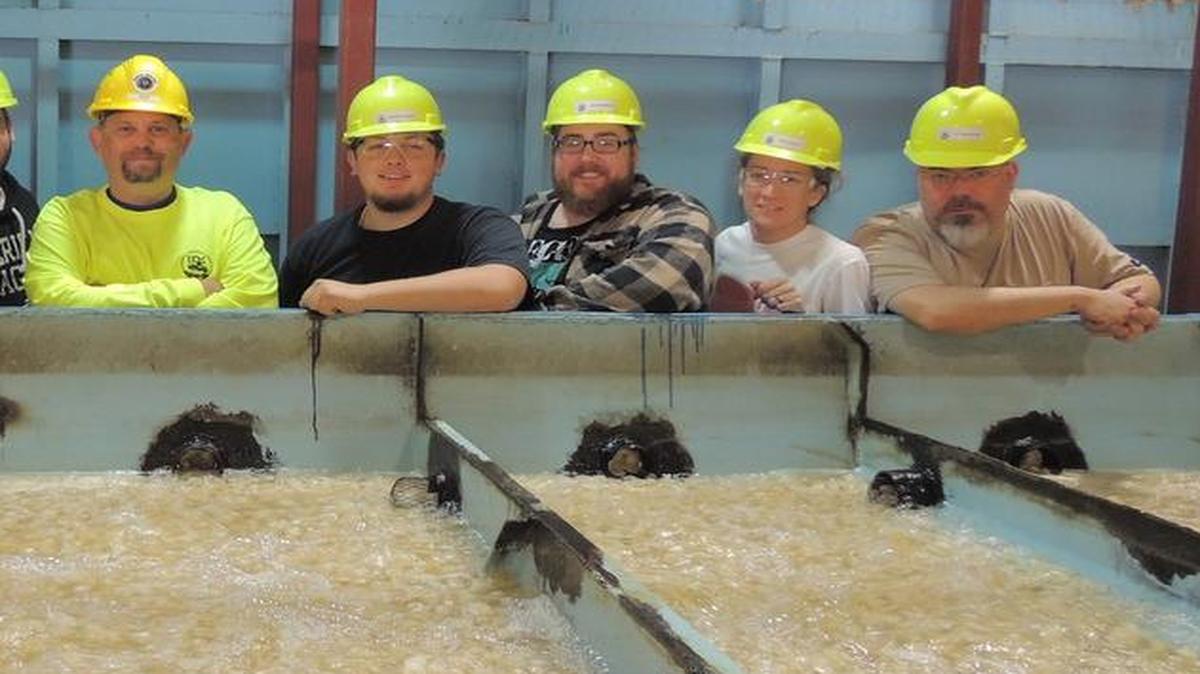 
The newly installed moving bed biofilm reactor is being looked over by students in the one-year Water Quality Control Operations Program at the Environmental Resources Training Center at SIUE. Pictured from left to right are Jim Hoffmann of Highland, Nate Bailey of Hardin, Justin Whitney of Smithton, Rick Lallish (program director), Branson Keehner of Jacksonville, Austen Zimmer of Highland, Paula Ledoux of Belleville, and Adam Mathews of St. Louis. Inset: On display is a close-up view of a plastic bio-disc.

