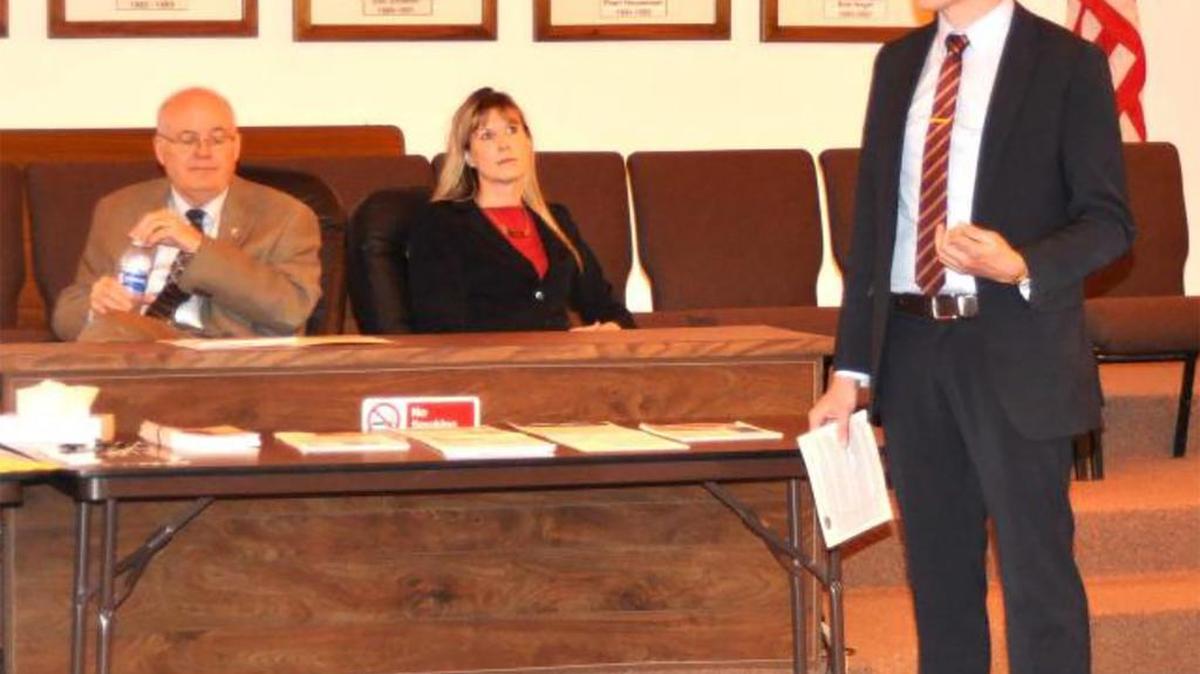 In background, Madison County Chairman Alan J. Dunstan, left, and Highland Assistant Manager Lisa Peck and listen to a presentation by Austin Korns of the Madison County Community Development Department.