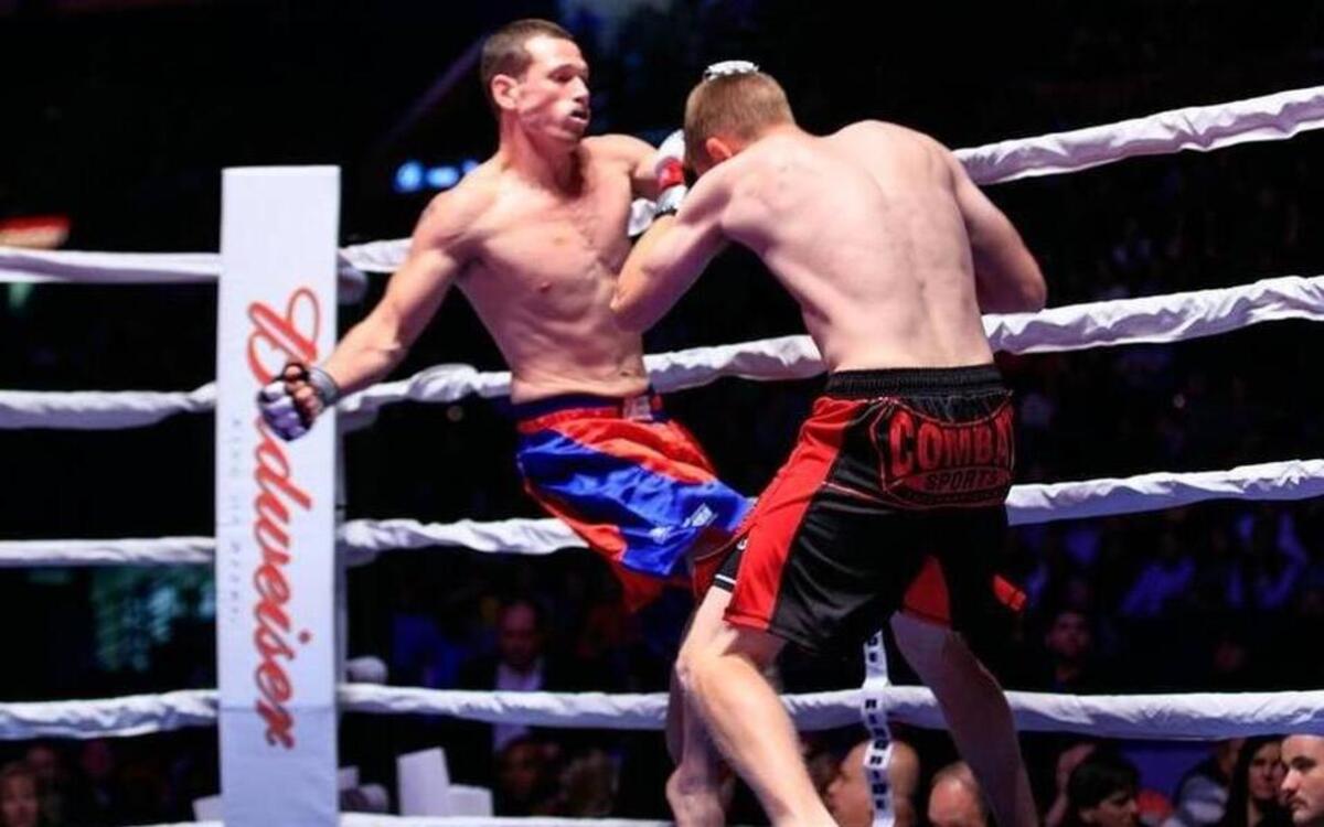 Highland police officer Nathan Biggs, left, fights Scott Lilly, a paramedic from St. Louis, at last year’s Guns ’N Hoses in St. Louis.