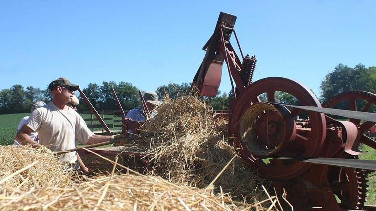 Scott Schuepbach forks straw into a baler at a previous Homestead Harvest Days in Highland. The 2019 event again will have a wide range of activities and events from adults and children.