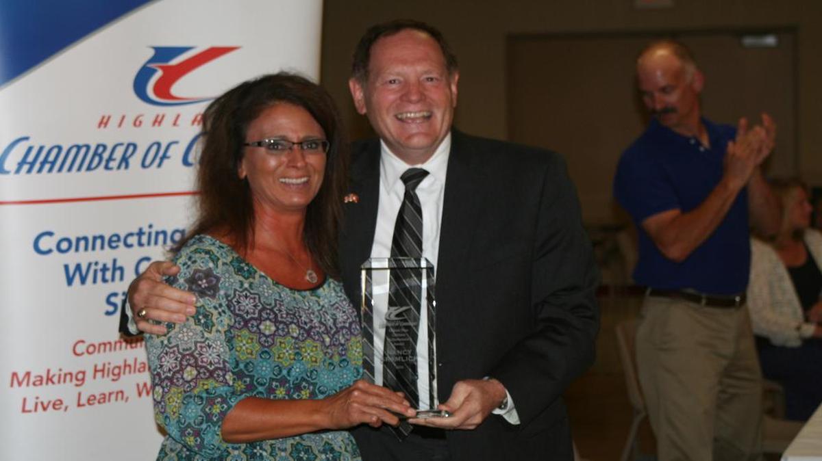 Nancy Gramlich (left) accepts the prestigious Homer Poss Lifetime Achievement Award from Chamber of Commerce Treasurer Howard Held (right).