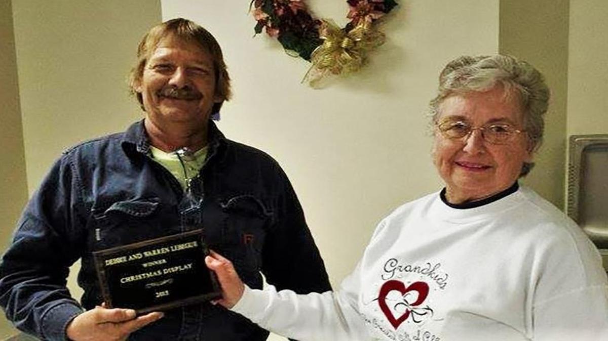 NEW DOUGLAS CHRISTMAS YARD DECORATION WINNERS PRESENTED WITH PLAQUE Warren and Debbie Lebegue won the Christmas decoration contest. Pictured, New Douglas Mayor June Ridensand were present Warren Lebegue with a commemorative plaque at Village Board’s January meeting.