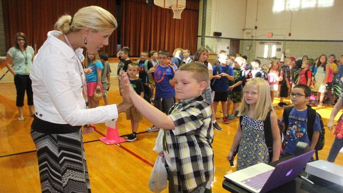 
Alhambra Primary School Principal Cindy Tolbert gives second-grader Darron Pharis a high five welcoming him back to school on the first day of school Wednesday.

