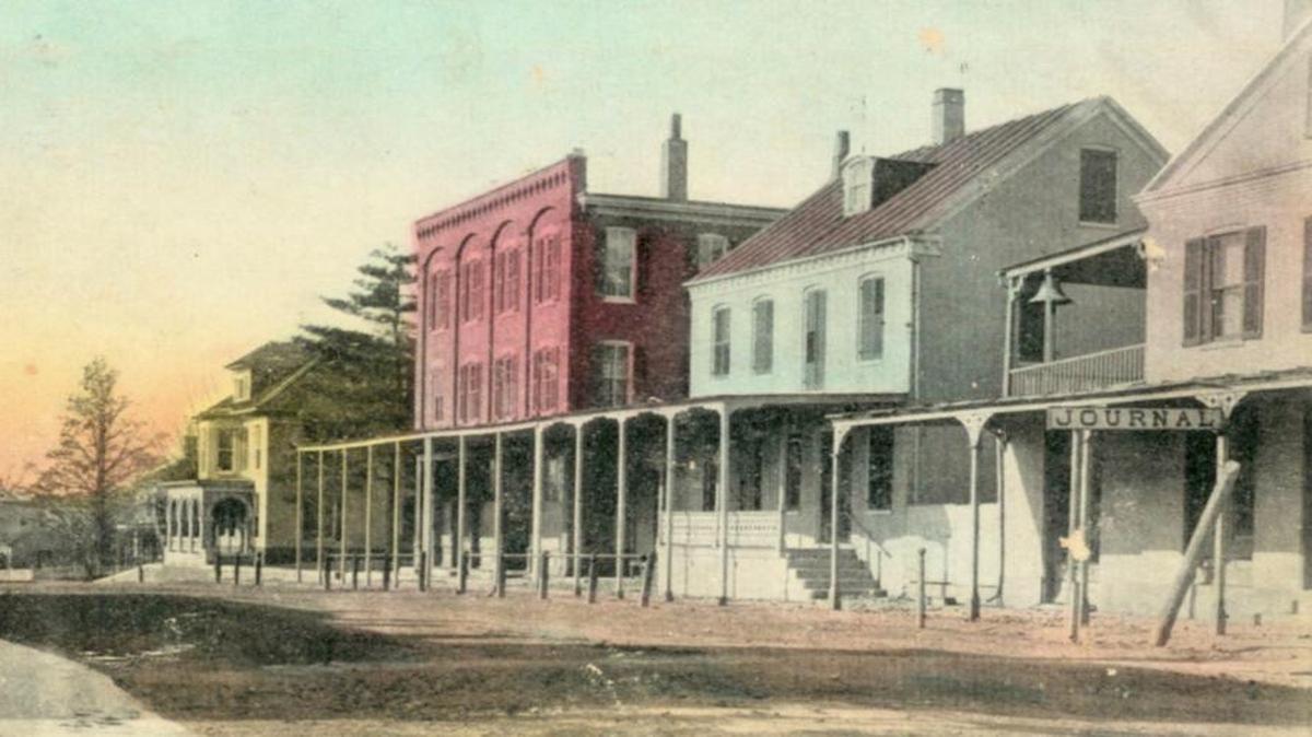 This photo shows Main Street, looking west from 801 Main St., in the early 1910s. There were mud streets, but concrete sidewalks. The first building on right is the John Suppiger store. Note the fire bell still on the porch ceiling. However, the fire department’s wide doors had been removed for a new entry to the Journal newspaper office. Down the street is the Breauchard Bakery Building, the three-story John Spindler Store, and the F. Ryhiner & Co. Bank building. The post card from the Roland Harris collection and will be given to the Highland Home Museum, along with many other Highland Streets.