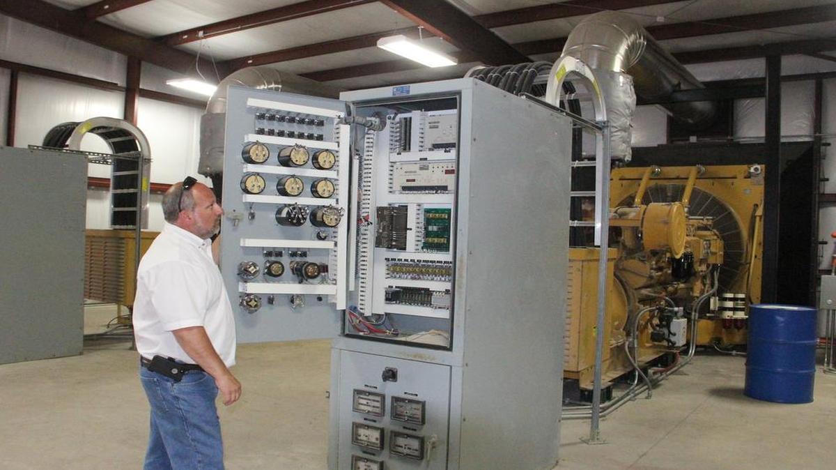
Dan Cook, Highland Light and Power director, stands in front of an existing controls in the power plant. The city will be replacing all of the controls plant this winter. All of the city’s controls failed to sync during an Aug. 23, 2014 power outage.
