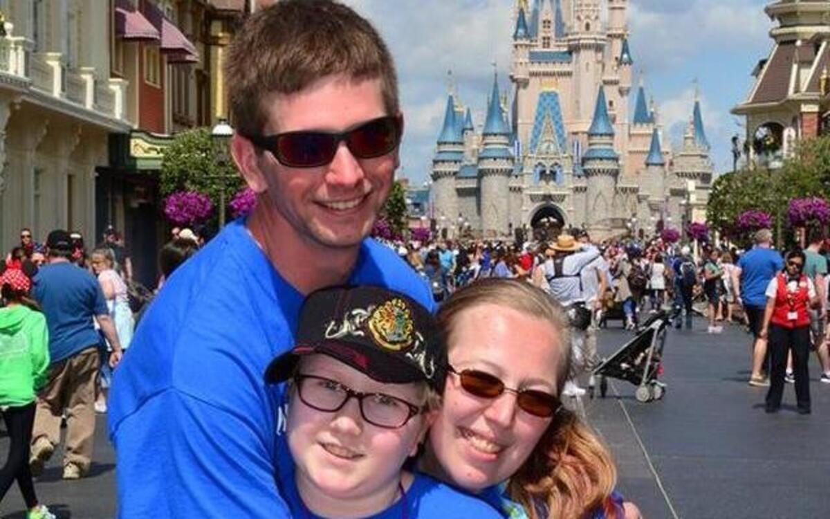 Abby Schrage takes a picture with her parents, Nathan and Jill Schrage, at Disney World in Orlando, Fla.