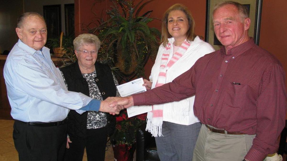 Pete and Jane Korte, shake the hand of the Relevant Pregnancy Options Center board president Paul Dunker and executive director, Tricia Blasdel. The Korte’s have provided the center with the two lots needed to build their new building. The organization has been working expand their facility, and Blasdel said the lots were the deciding factor in their affordable construction.