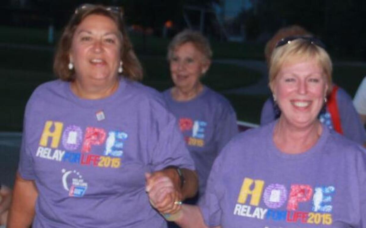 
Kim Winter of Highland, a five-year survivor of breast cancer, and Shirley Landers of Highland, a 23-year survivor of cervical cancer, walk in the survivor lap at Friday’s Relay for Life of Highland ceremonies.
