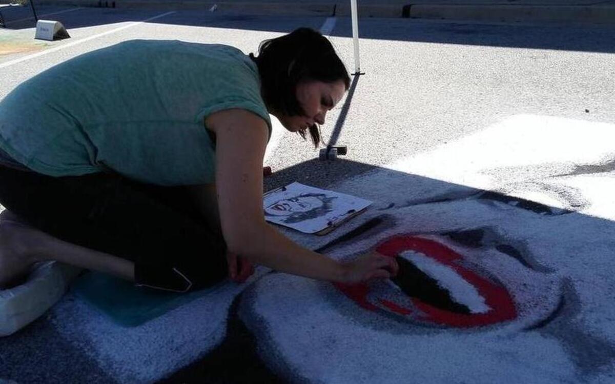 Taylor Sheeley recreates an iconic image of Marilyn Monroe for her piece at the Street Art Festival last year in downtown Highland.