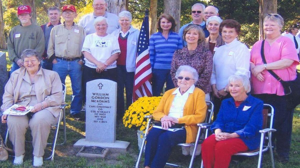 Descendants of Revolutionary War veterans William McAdams gather around his new grave marker at Dugger Cemetery during a recent Memorial Day celebration there.