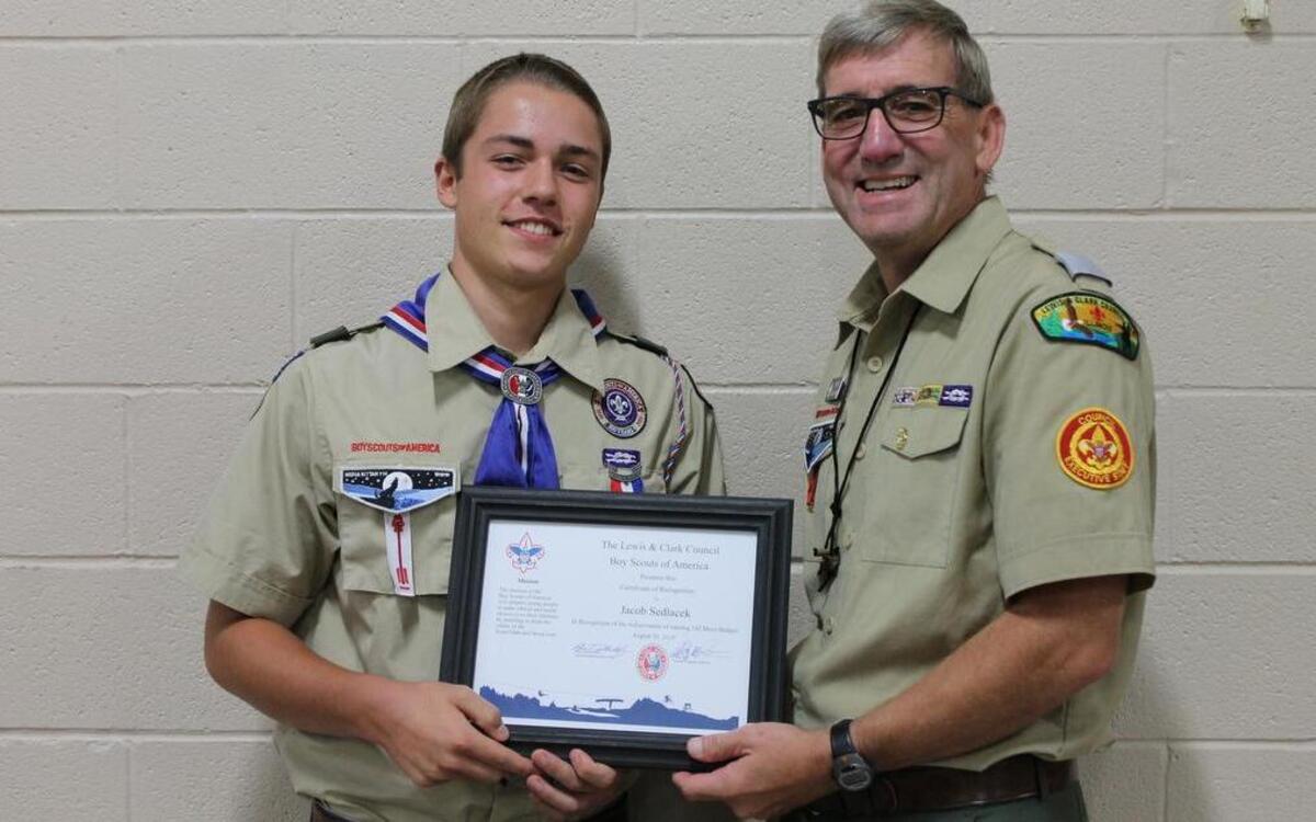 Triad High School junior Jacob Sedlacek receives his Certificate of Recognition from Phil Reis, program director with the Lewis and Clark Council. Sedlacek has received every Boy Scouts of America merit badge, including an Eagle Scout ranking.