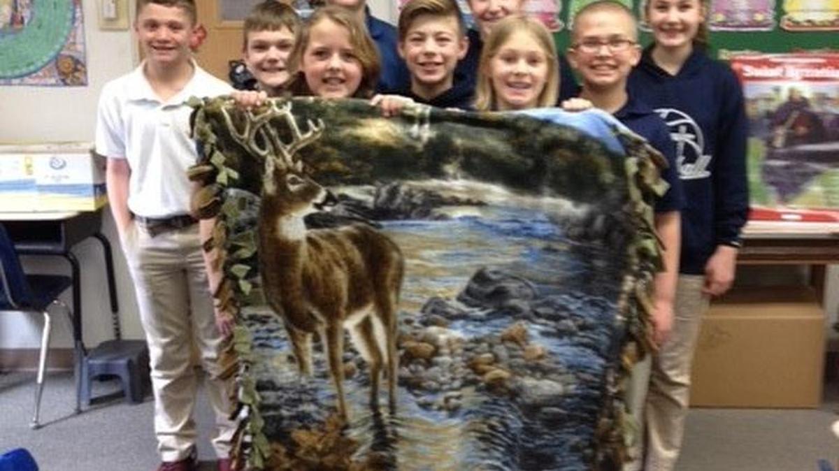 St. Paul students show off one of the blanket they made. Front row from left are Kori Huelsmann and Carley Emig; second row, Drew Schonhardt, Patrick McGinley and Drew Douglas; third row, Brenden Gelly, Heath Follwell, Grace Wilke and Madelyn Vogelbacher.