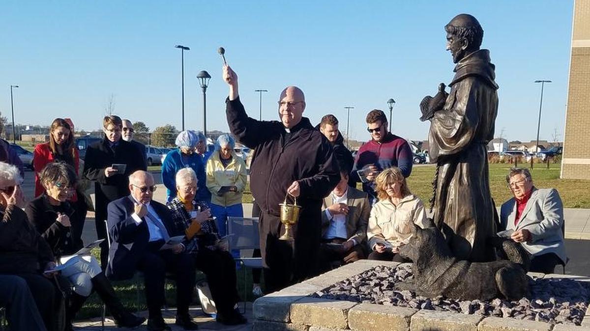 Pat Jakel of St. Paul Catholic Church gives a blessing for the new statue of St. Francis of Assisi outside St. Joesph’s Hospital in Highland.