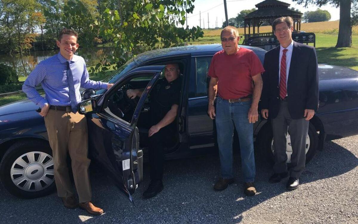 From left, Madison County Board District 4 member David Michael, St. Jacob Police Chief Steve Howe, St. Jacob Mayor Richard Schiefer and Madison County Board Chairman Kurt Prenzler are pictured with a vehicle sold by the county. St. Jacob purchased the vehicle for $1 through a program initiated by the board.