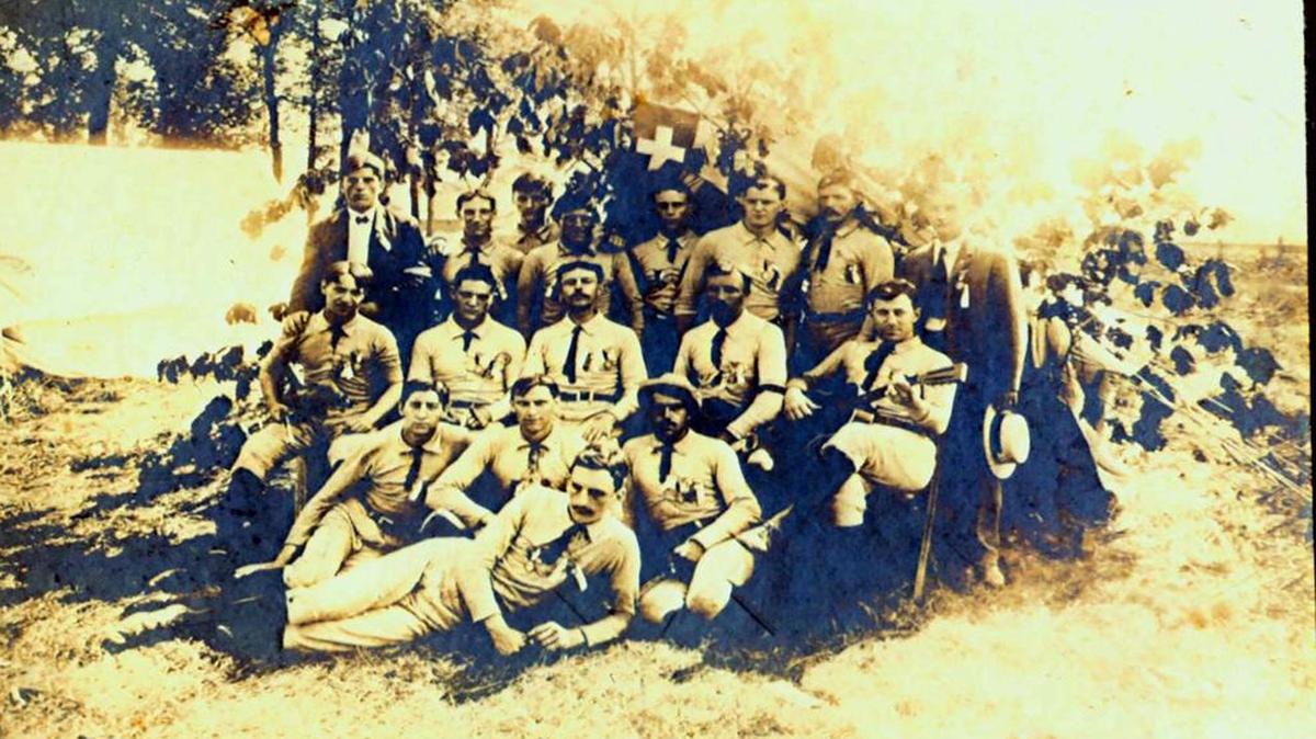 The first meeting to plan for the Grand Army of the Republic of Highland, thought to be held at the Diamond Mineral Springs Hotel in Grantfork. Only seven men have been identified. Front row, second from left, on knees, is Henry Rutz; fourth is Rudolph Kaufmann; and seventh, Adolph Mueller. Back row, first man on the left is Anton Kraft; third is George Roth; seventh is Maurice Marcoot, in front of flag; eighth, seated in front of flag, is Anton Hundsdorfer. This identification was done by Robert Gerling in his booklet, “Highland: An Illinois Swiss Community in the American Civil War”. Original photo courtesy of Mr. and Mrs. John Marcoot and daughter-in-law Linda of Greenville. (Do you have additional names? If so please call, 654-5005.