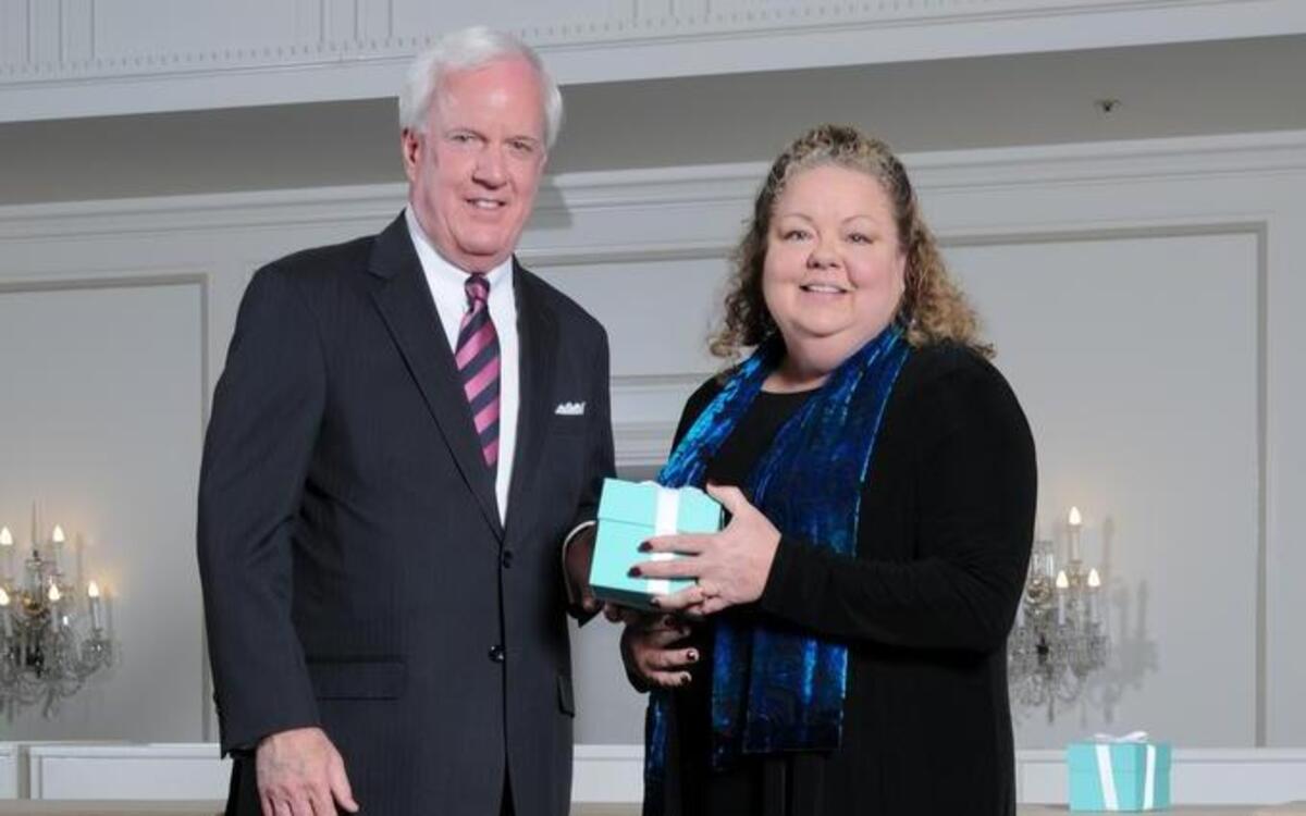 Pat Sly, executive vice president at Emerson, presents an Emerson Excellence in Teaching Award to Highland music teacher Lori Ruebhausen.