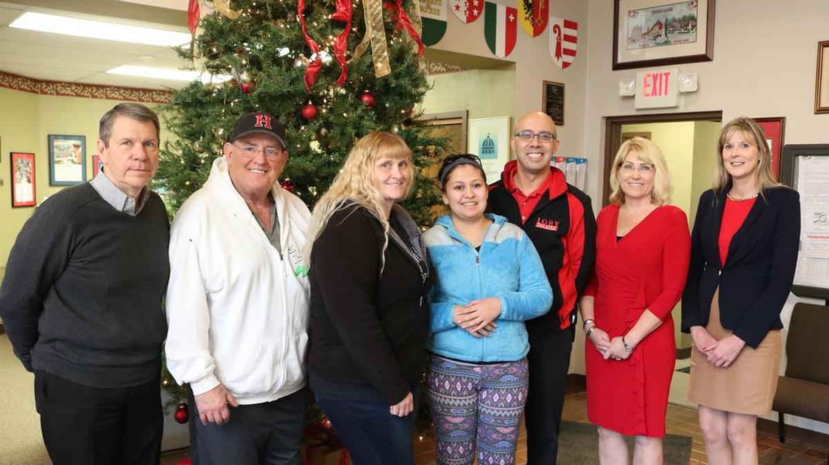 From left to right, City Manager Mark Latham, Mayor Joe Michaelis, Coral Cantrell-Romero, Ana Cantrell, owner of Lory Theater Justin McLaughlin, Louis Latzer Memorial Public Library Director Angela Kim, and Assistant City Manager Lisa Peck. In May, Ana Cantrell was invovled in a train-car collision, which left her with high medical bills with no health insurance. Recently, Michaelis worked in his own way to find holiday presents from the community for the Cantrell family.