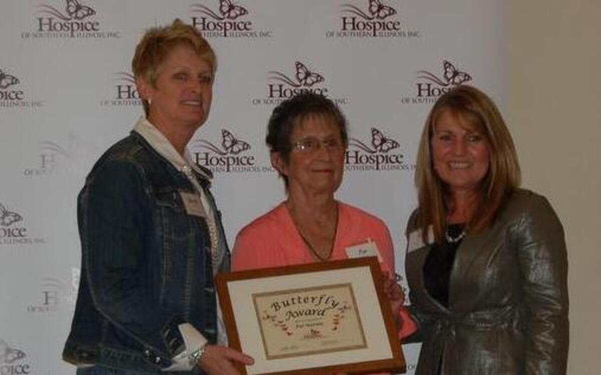 Shelly Black (on left), Hospice of Southern Illinois volunteer services supervisor, and Sally Koval (on right), volunteer service coordinator, present Pat Maroon of Highland with the Butterfly Award” at the organization’s annual dinner on April 8.