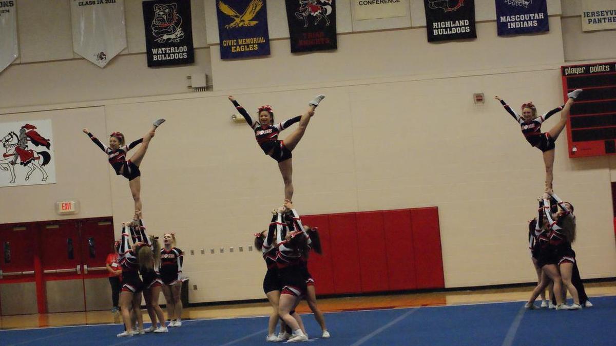 The Highland High School varsity cheerleading team perform a stunt early in their routine en route to winning the medium team division at the IHSA Triad Sectional on Saturday at Triad High School.