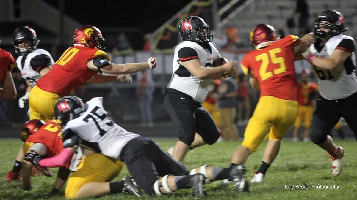Highland senior Colten Knebel is usually the starting left guard on the offensive line but here he is shown getting to tote the ball as he follows his blocking, including by his twin brother, Dylan Knebel, on the right side of the photo. Colten Knebel rumbled for a 25-yard gain on the play and later on, Dylan Knebel had a 25-yard run of his own.