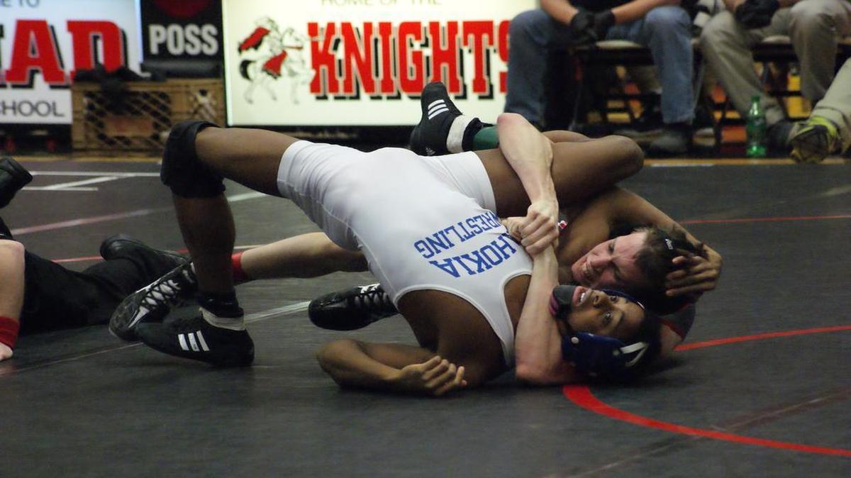 Highland junior Jacob Mitchell scores three points for wrapping up Cahokia’s Rooney Evans in the cradle during Mitchell’s 9-4 victory in the third-place match at 126 pounds at the IHSA Class 2A Triad Wrestling Regional Feb. 6 at Triad High School.