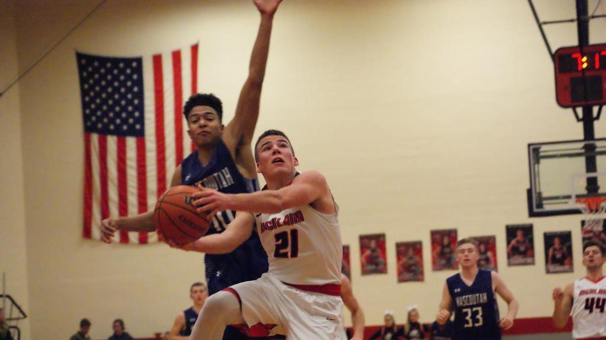 Highland’s Brady Feldmann gets inside as Mascoutah’s Jaydon Stewart contest from behind during the first half of the Bulldogs’ 66-60 victory over the visiting Indians Tuesday, Jan. 30 at HHS.