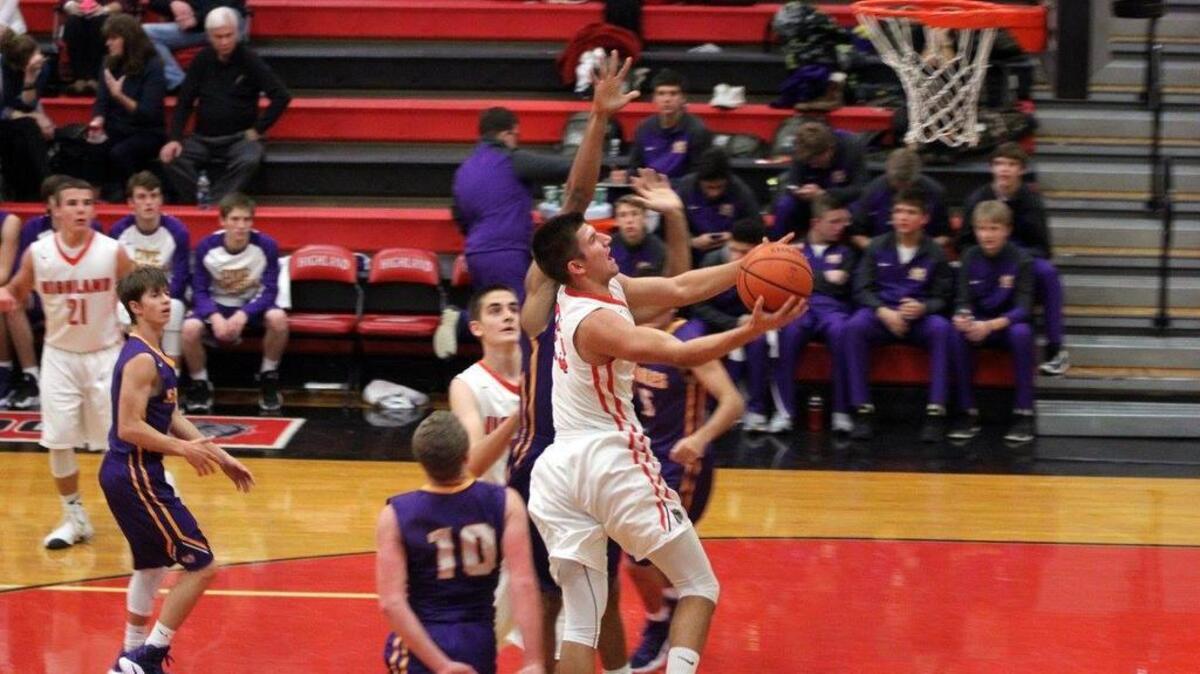 Highland forward Stephen Schniers puts up a shot in the post during a 70-62 home win over Civic Memorial last year. Schniers is the Bulldogs’ top returning senior this season.