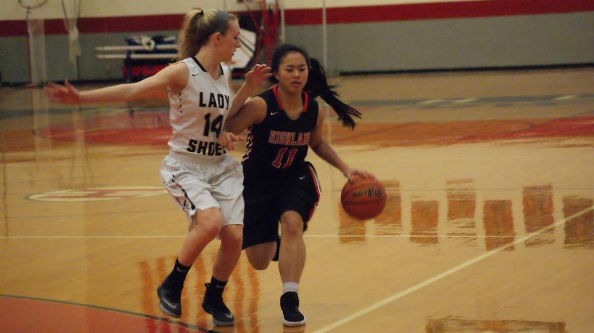 Highland junior Emmy Nyquist dribbles to the top of the key while being guarded by Teutopolis senior Marianna Hemmen during the first half of the Lady Bulldogs’ 44-36 upset victory Tuesday night in the quarterfinals of the 32nd Annual Highland Scott Credit Union Girls Basketball Tournament.
