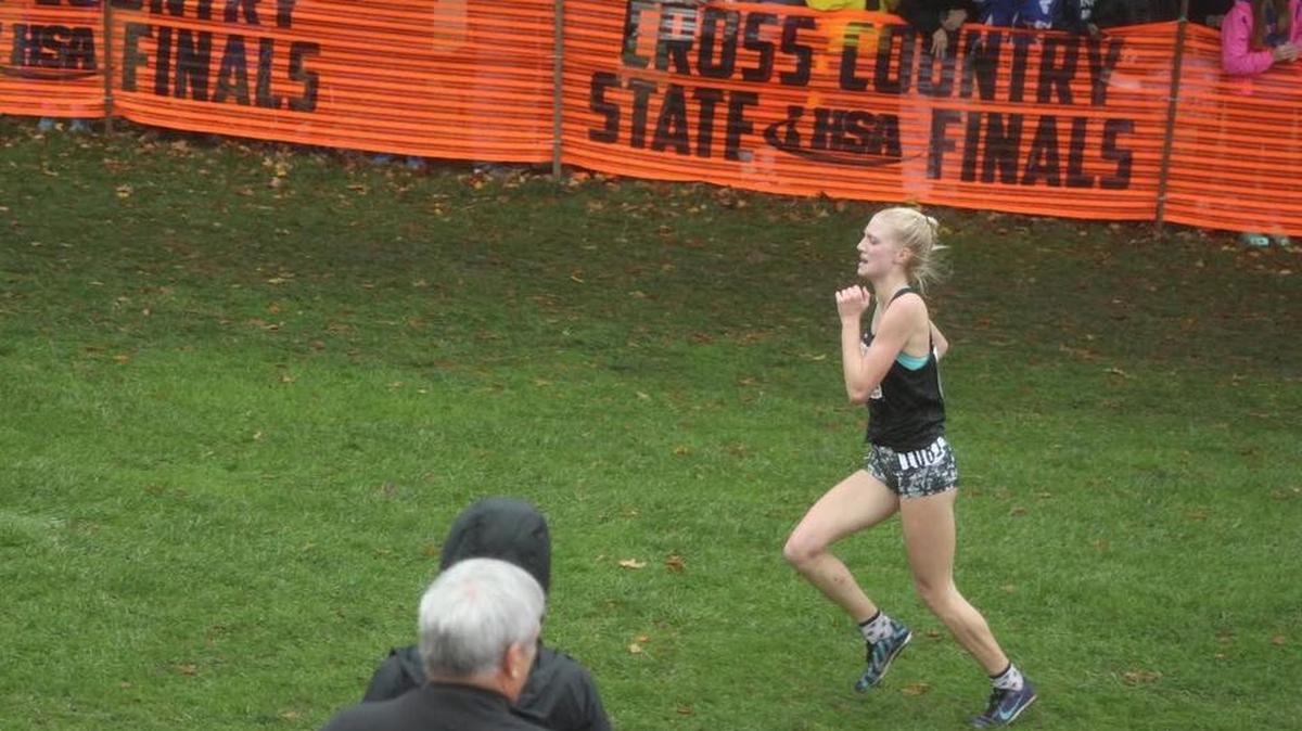 Highland sophomore Sam Hengehold runs just a few yards from the finish line where she crossed in 37th place out of 208 runners in the second fastest time in school history at 18:21 at the IHSA Class 2A Girls State Cross Country Meet Saturday at Detweiller Park in Peoria.