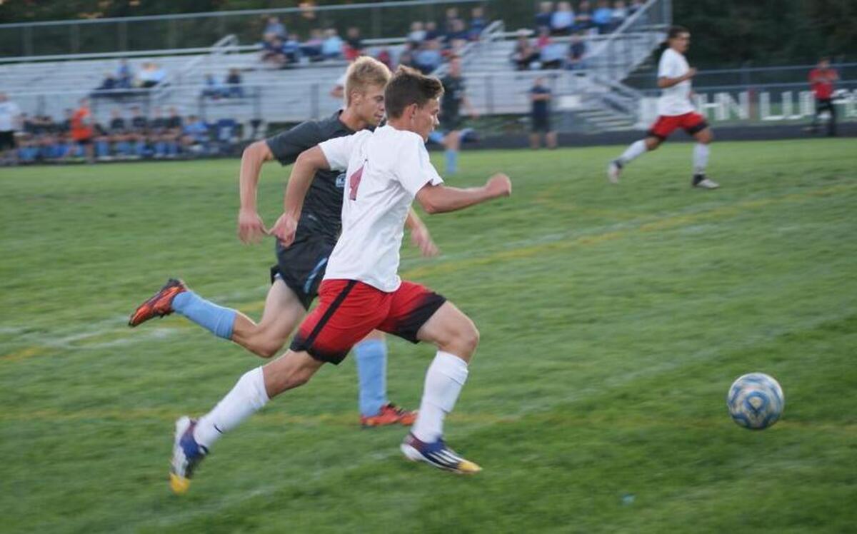 Highland senior forward Brent Rapien runs with the ball ahead of Jerseyville senior midfielder Drake Blackwell during the first half of the Bulldogs’ 2-0 win over the Panthers on Senior Night on Tuesday of last week at the HHS stadium. Two nights later, Rapien suffered a serious concussion in a 3-3 tie at Waterloo and very likely could miss the rest of the season.