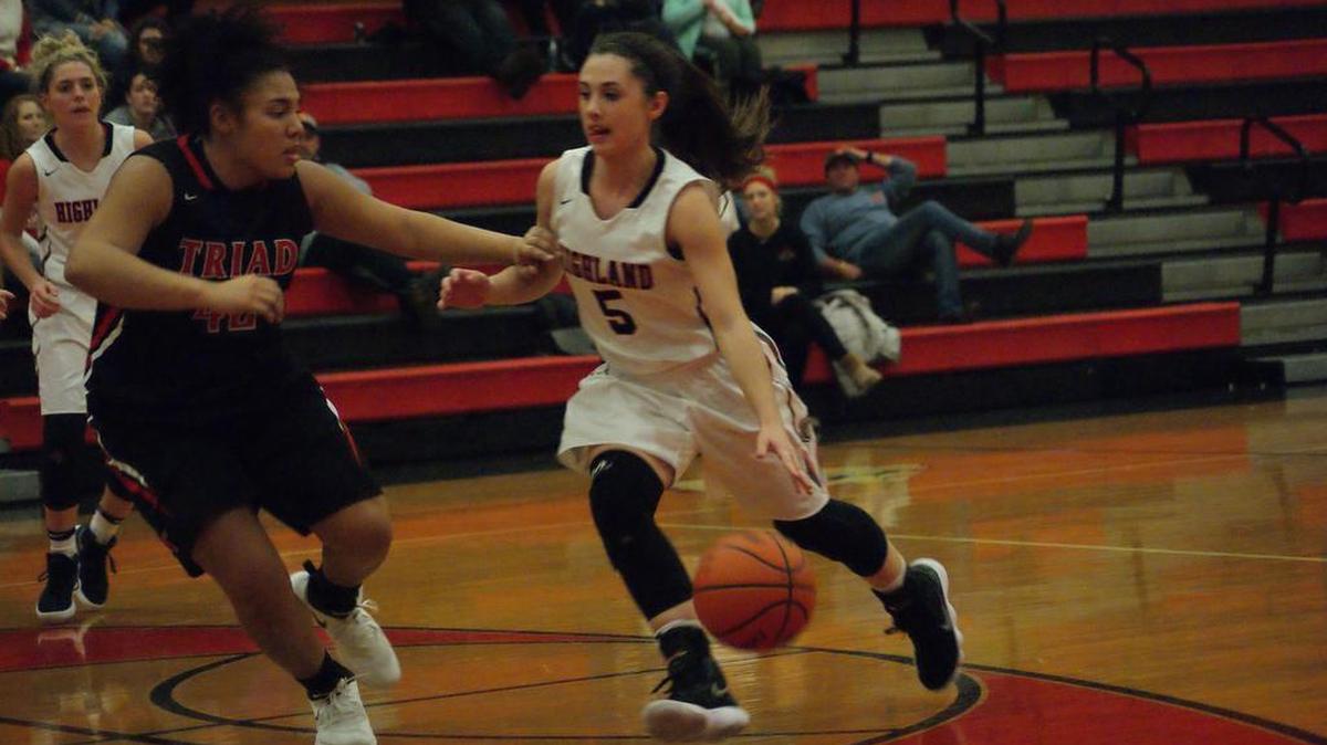 Highland sophomore guard Elllie Brown drives looks to drive down the lane against Triad junior Molly Suess during the first half of the Lady Bulldogs’ 72-39 drubbing of the visiting Knights on Thursday.
