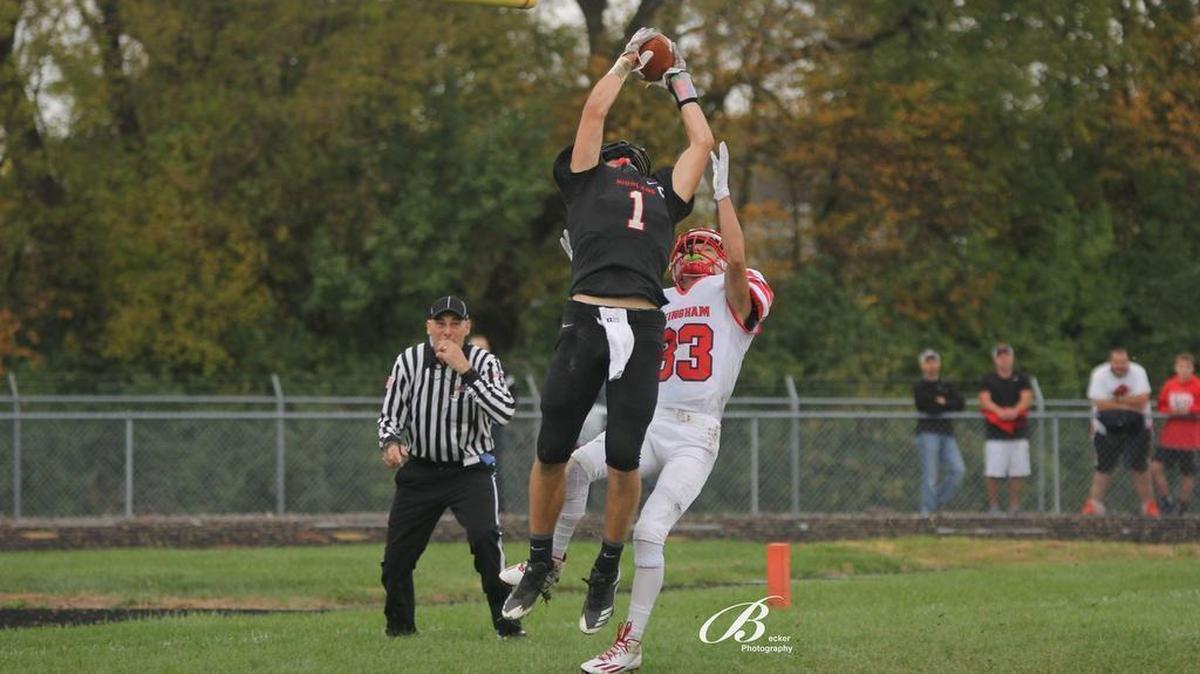 Highland junior Sam LaPorta stretches to snag a 27-yard touchdown reception over Effingham’s Kody Line to help put the Bulldogs up 43-14 in the second quarter of their 57-14 rout of the visiting Flaming Hearts Saturday afternoon in the second round of the Class 4A playoffs.