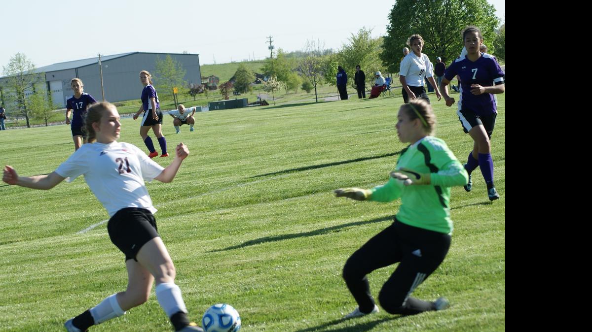 
Highland sophomore Alisse Koishor gets in close to let loose shot at Mascoutah’s goal while Indian keeper Sam Barnhart goes down to try and stop the shot during the second half of the Lady Bulldogs’ 3-0 win over visiting Mascoutah last Thursday at Glik Park.
